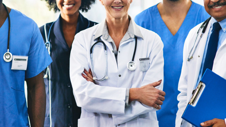 The picture features several people, all wearing scrubs or lab coats, who work in the medical or referral fields.