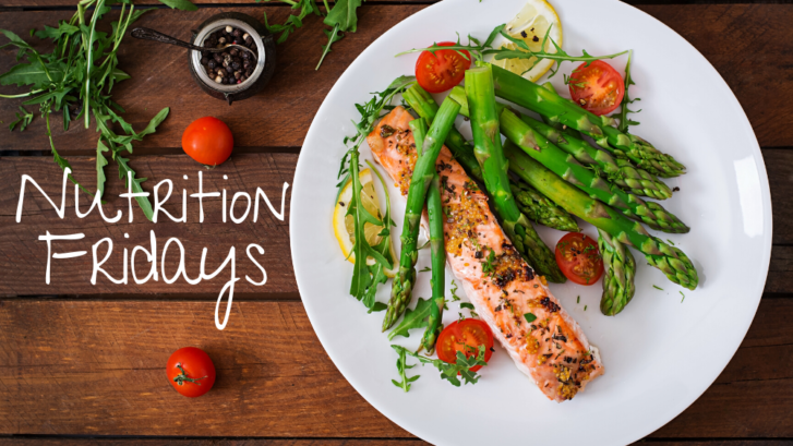 The image displays a white plate with colorful looking food on it- bright green asparagus, pink baked salmon, and cherry red tomatoes. This is an example of a nutritious meal.