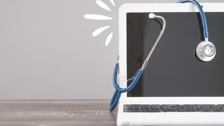 A white laptop with a blue stethoscope on its screen.