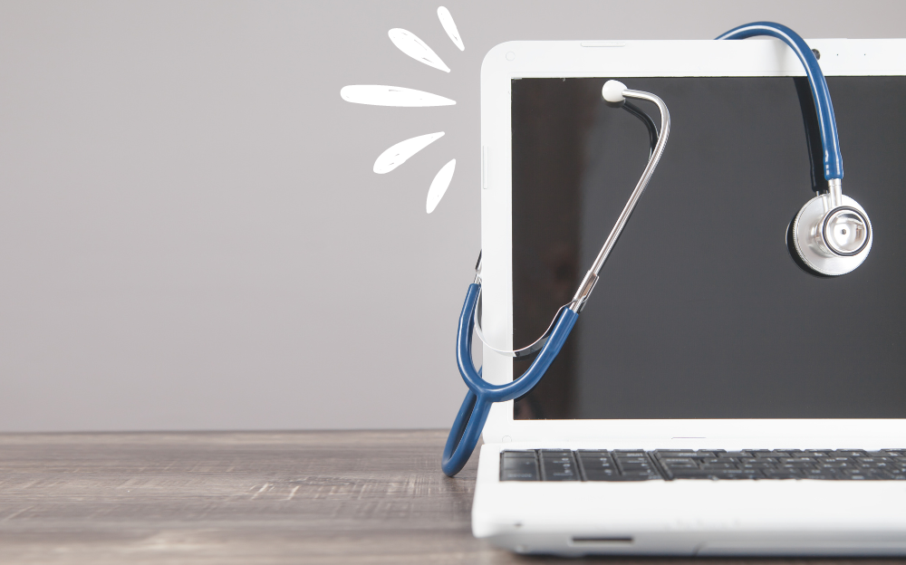 A white laptop with a blue stethoscope on its screen.