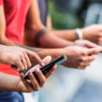 hands holding cell phones and texting