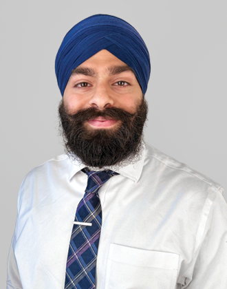 Headshot photo of Dr. Bajaj, who is wearing a blue Dastar, which is a traditional head covering. He is in a white dress shirt and blue tie.